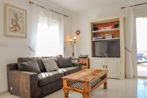 a living room with a couch and a coffee table at Sea View Family Villa with Private Pool, San Juan de los Terreros in Pulpí