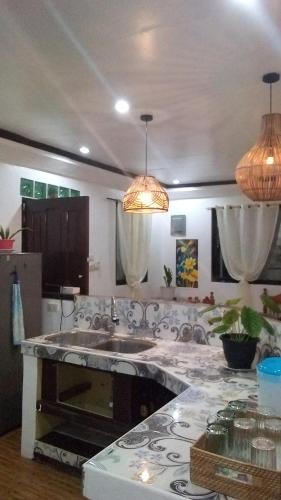 a kitchen with a sink and a counter top at JML homestay in General Luna
