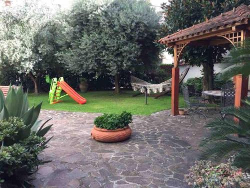 a backyard with a playground with a slide at I due ulivi in Arzano