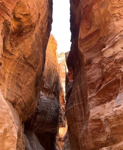 a view of the canyon from inside the slot canyon at Wadi Rum Legend Luxury Camp in Wadi Rum
