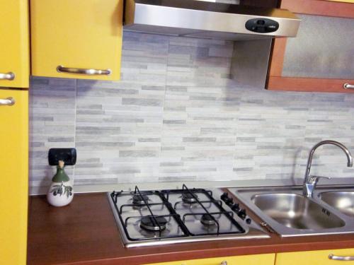 a kitchen with a stove and a sink at I due ulivi in Arzano