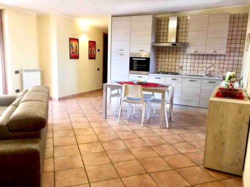 a kitchen with a table and chairs in a room at I due ulivi in Arzano