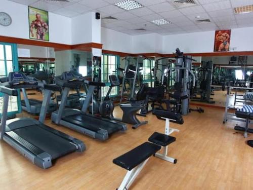 a gym with lots of exercise bikes and treadmills at RAMEE SUITE 3 in Manama