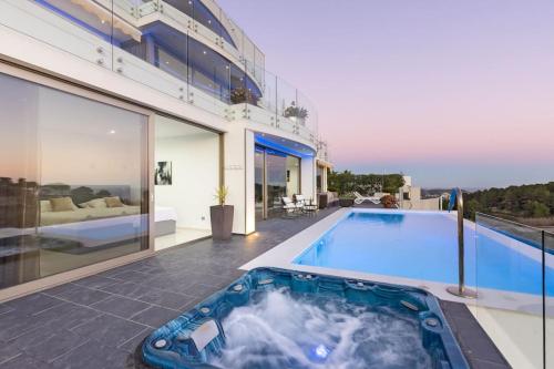 a swimming pool in the middle of a house at Moonlit BB Spa Art boutique Cab in Teulada