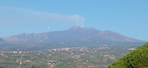 a distant view of a mountain with a town at Home Tropicana in Mascali