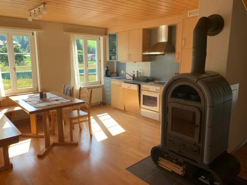 a kitchen with a stove in the middle of a room at Dachwohnung Zentrum Unterwasser in Unterwasser