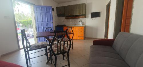 een woonkamer met een bank en een tafel en een keuken bij Şahin Apart in Bodrum City