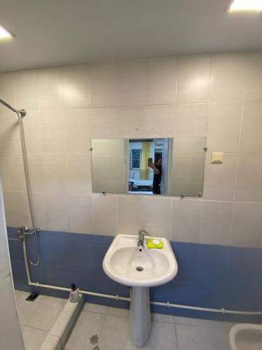 a bathroom with a sink and a mirror at Cozy Suit with pool in Yerevan
