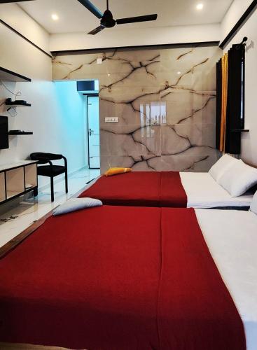 a bedroom with a large bed with a red blanket at Rock Lake Villa in Vagamon