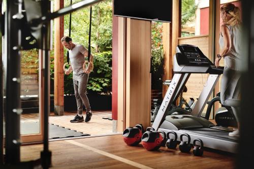 a man standing in front of a gym with a treadmill at MalisGarten Green Spa Hotel - Adults Only in Zell am Ziller