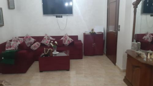 a living room with a couch and a tv at Zahrae 2 blok 1 in Ksar el Kebir
