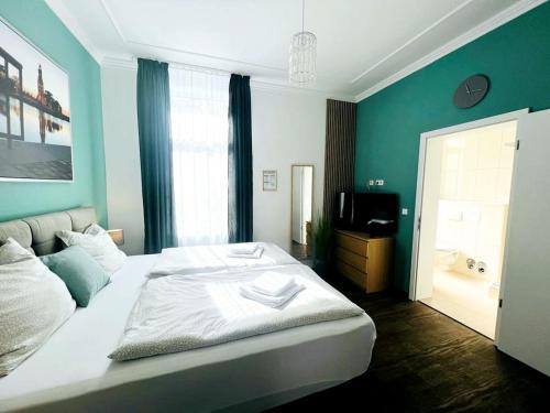 a bedroom with a large bed and a television at Ferienwohnungen an der Weser in Bremerhaven