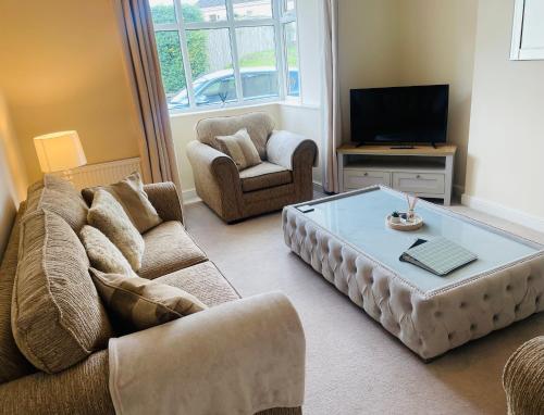 a living room with a couch and a coffee table at The Graph’s Gaff in Aycliffe