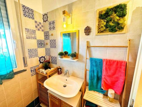 a bathroom with a sink and a mirror and a towel at Meizon Business Tower, Imbarco traghetti Sicilia e Sardegna, terrazzo esclusivo, Wi-Fi Super veloce, parcheggio riservato in Genoa