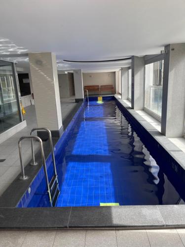 a swimming pool with blue tiles in a building at Embassy apartment free parking in Adelaide