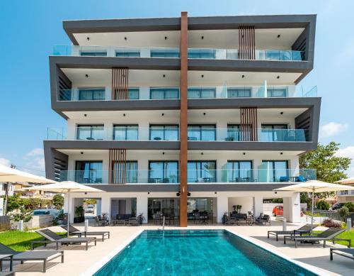 an exterior view of a building with a swimming pool at Waterside Sea View Apartments in Paphos City