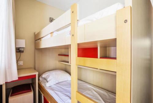 Ce lit superposé se trouve dans une petite chambre dotée de lits superposés. dans l'établissement Superbe Appartement Village Cap Esterel 4p climatisé, à Saint-Raphaël