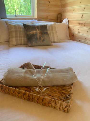 a bed with a basket on top of it at Dwell on the Moor in Holme upon Spalding Moor