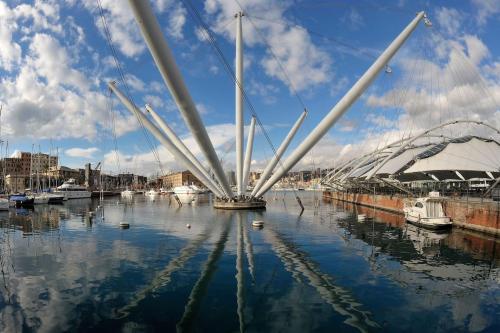 a sail boat in the water in a harbor at La Palma di Rafé in Genova