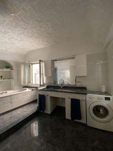 a kitchen with a sink and a washing machine at La Palma di Rafé in Genova