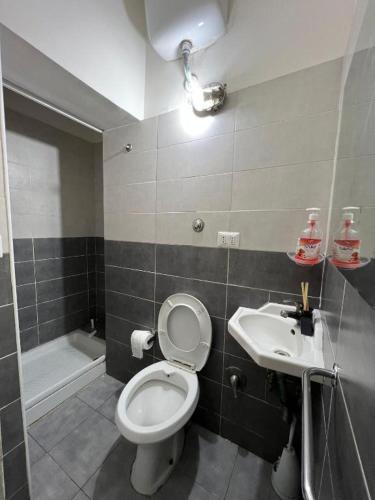 a bathroom with a toilet and a sink at Baraka Guest House in Rome