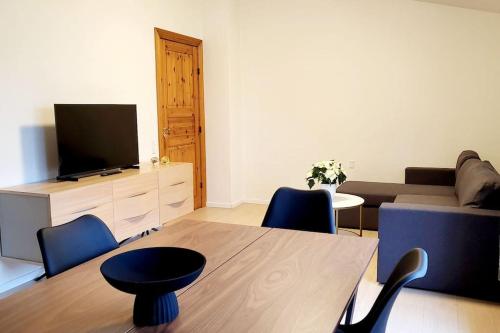 a living room with a couch and a table with chairs at SoloRica House(400m to Lego House,1km to Legoland) in Billund