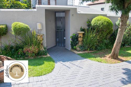 a walkway leading to a door in a house at Stay @ Honeytree in Edenvale
