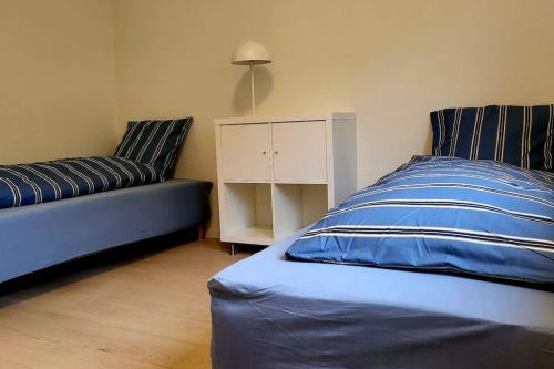 a bedroom with a blue bed and a couch at SoloRica House(400m to Lego House,1km to Legoland) in Billund