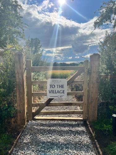 a gate with a sign that reads exit to the village at Dwell on the Moor in Holme upon Spalding Moor