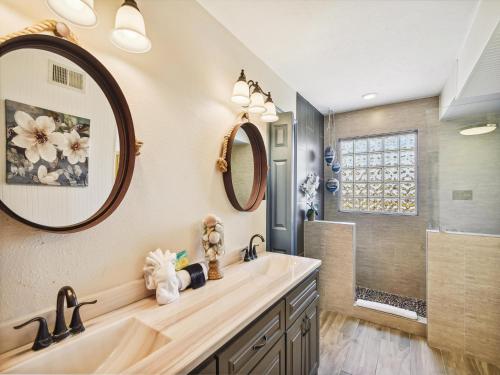 a bathroom with a sink and a shower at Tiki Lagoon in Galveston