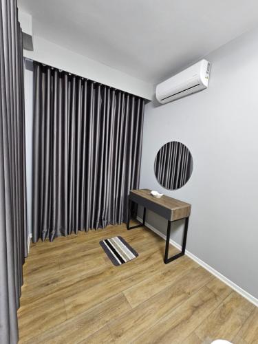a living room with a table and a window at Tirana Apartment KDK in Tirana