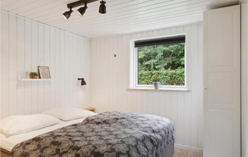 a bedroom with a bed and a window at 3 Bedroom Amazing Home In Silkeborg in Silkeborg