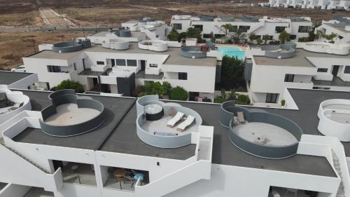 an aerial view of a building with hot tubs at Luxury aparment in casilla de costa with Jacuzzi- Follow the sun in La Oliva