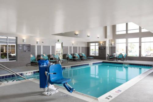 a swimming pool with a blue apparatus in a building at Residence Inn by Marriott Denver Central Park in Denver