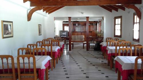 una habitación con hileras de mesas y sillas en un edificio en Hotel Agnanti, en Ágios Konstantínos