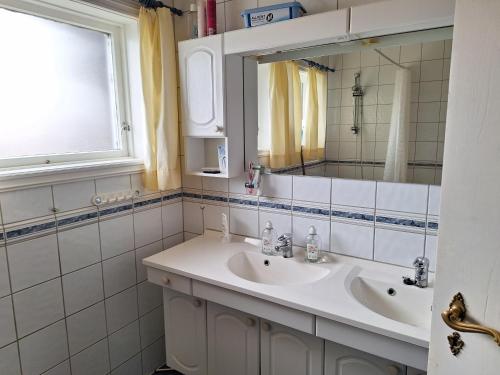 a bathroom with two sinks and a mirror at Stemmen 16 in Bryne