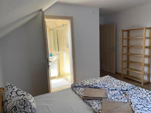 a bedroom with a bed and a door to a bathroom at Skh 3 in Praid