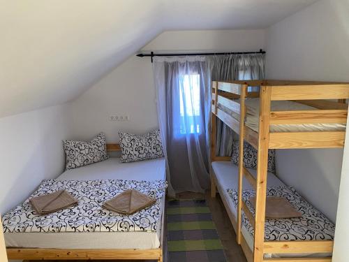 a bedroom with two bunk beds and a ladder at Skh 3 in Praid