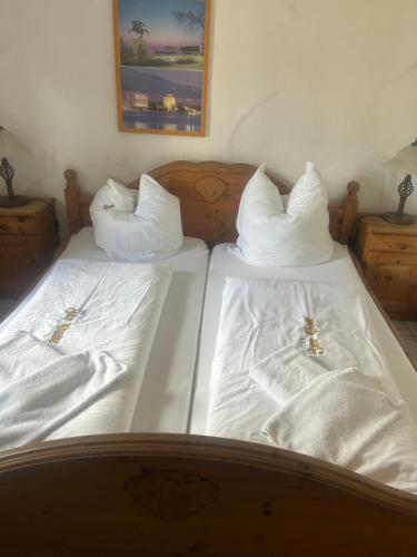 two beds with white sheets and white pillows on them at Gasthof zur Post in Siegen