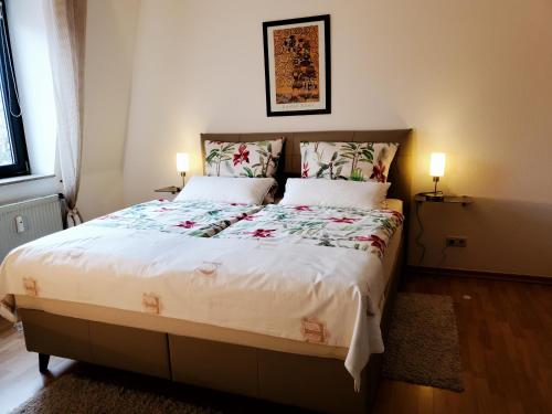 a bedroom with a large bed with two pillows at Komfort FeWo Stadt Mitte in Trier