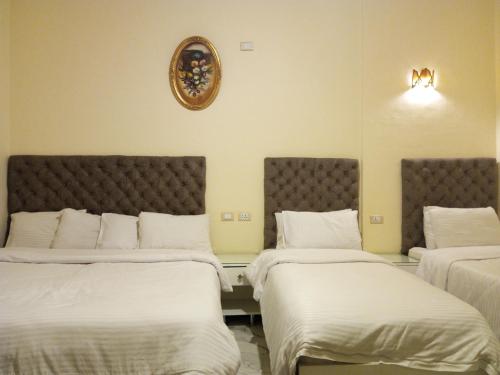 Postel nebo postele na pokoji v ubytování New Panorama Palace