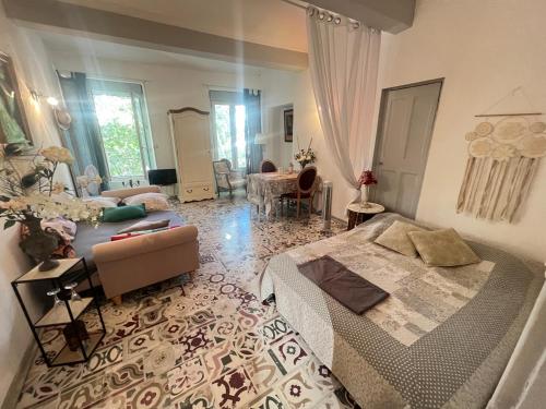 a living room with two beds and a couch at Les Coulisses de l'HORLOGE - WIFI - 50 m Palais des Papes in Avignon