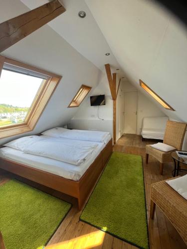 a bedroom with a bed and a large window at Landhaus Balkhausen in Nürburg