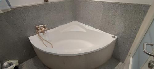 a white bath tub with a faucet in a bathroom at Geinberg Suites & Via Nova Lodges in Polling im Innkreis