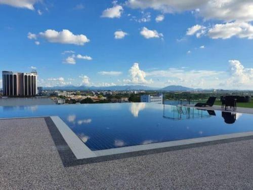 a swimming pool on the roof of a building at Infinity Pool at Kozi Square Homestay in Kuching