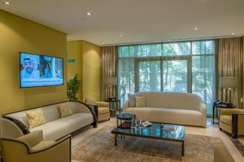 a living room with a couch and a table at Vivienda Hotel Villas Granada in Riyadh