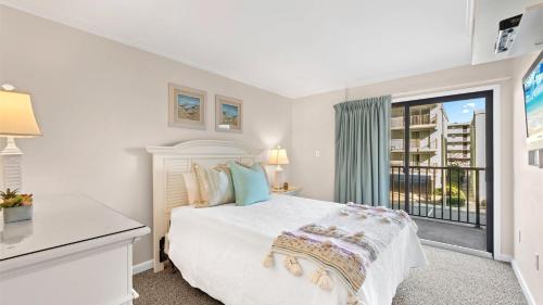 a white bedroom with a bed and a window at Ocean Time in Ocean City