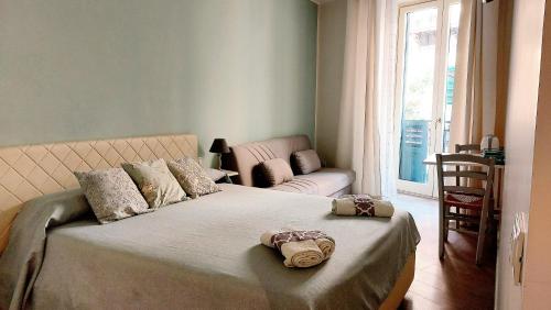 a bedroom with a large bed and a couch at Persiane al Cassaro in Palermo