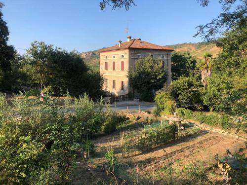 an old building in the middle of a field at Palazzo Giulia in Brisighella