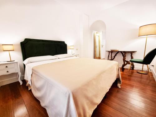a bedroom with a bed and a desk and a chair at Charme & Chic San Giacomo in Rome